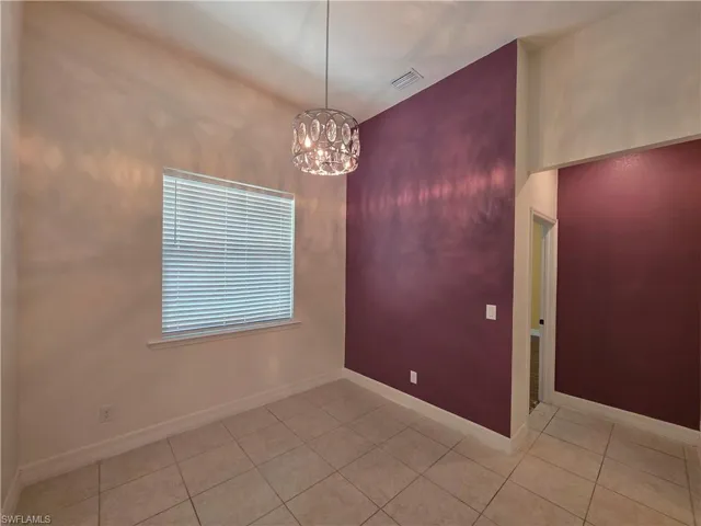 Recessed lighting, tile flooring, window with blinds, modern light fixture, and contrasting accent wall