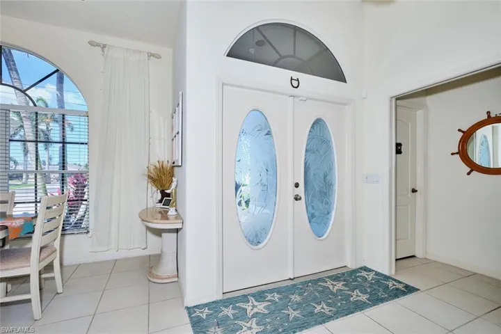 Entryway featuring double doors with glass