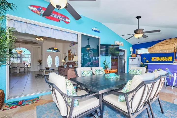 Dining space featuring tile patterned floors, lofted ceiling, and ceiling fan