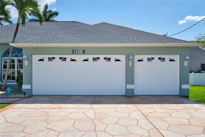 3 CAR GARAGE with Stamped concrete driveway
