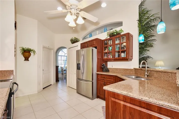 Kitchen with stainless steel refrigerator with ice dispenser