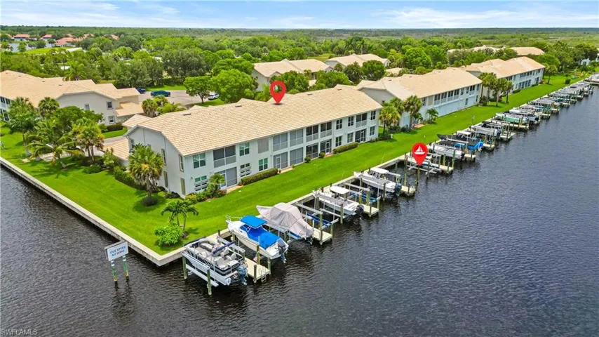 Waterfront complex with multiple boat slips featuring direct water access