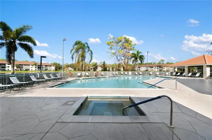 View of swimming pool with a patio and a community hot tub