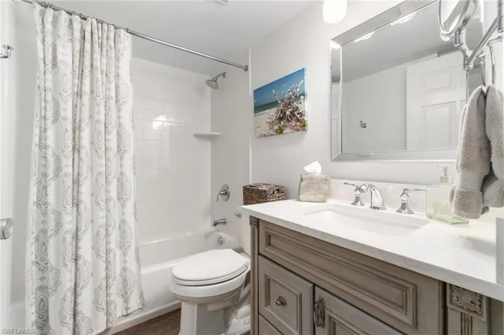 Full bathroom featuring shower / bath combo, vanity, and toilet