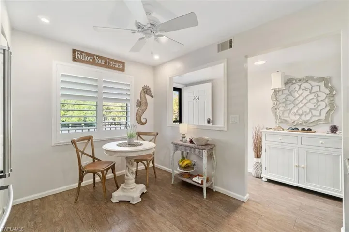 Living area with light hardwood / wood-style flooring and ceiling fan