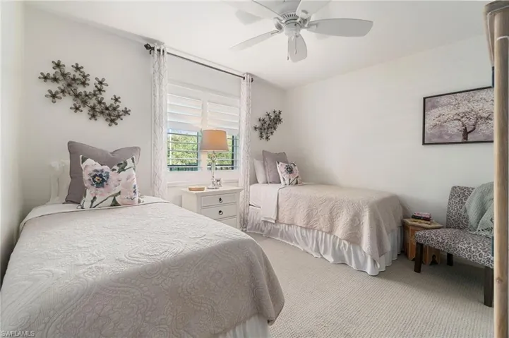 Bedroom featuring ceiling fan and carpet