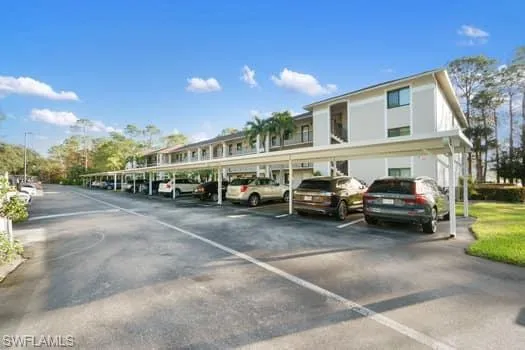 View of vehicle parking featuring a carport