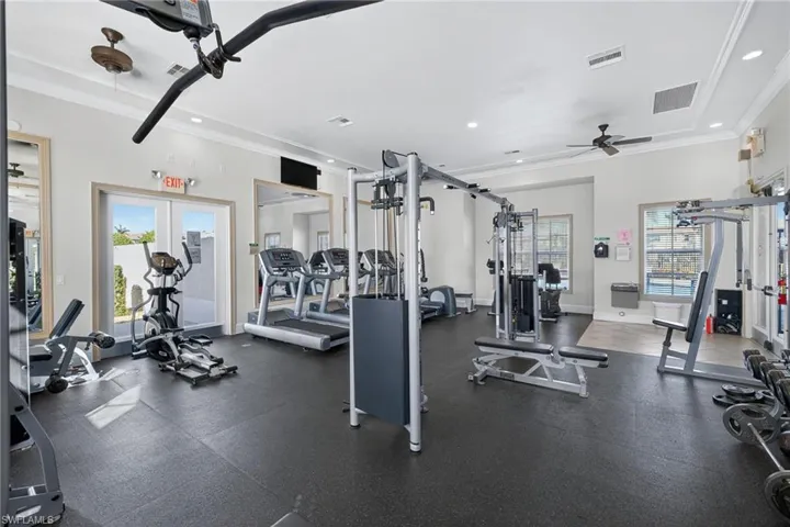 Workout area featuring ceiling fan, ornamental molding, and recessed lighting