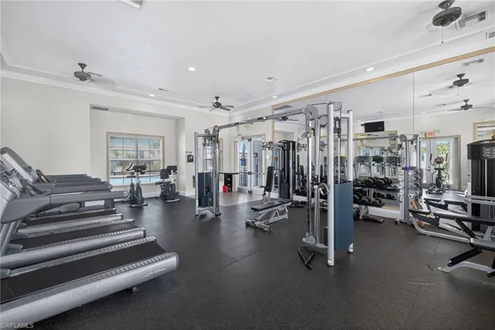 Workout area featuring ceiling fan, ornamental molding, and recessed lighting