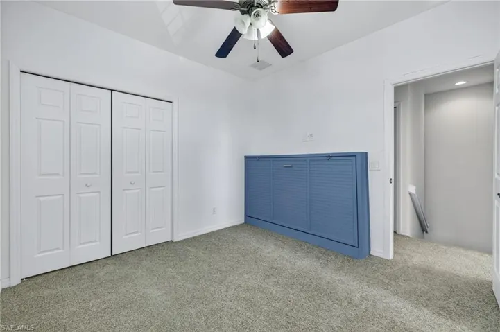 Unfurnished bedroom with carpet floors, a closet, and ceiling fan