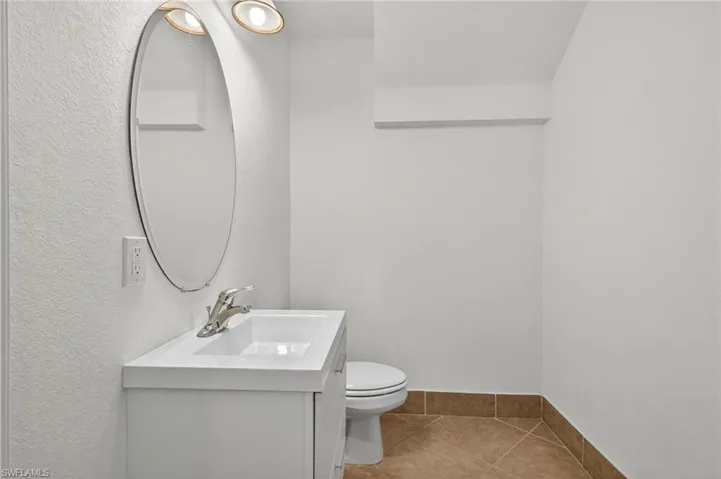 Bathroom with vanity and light tile patterned flooring