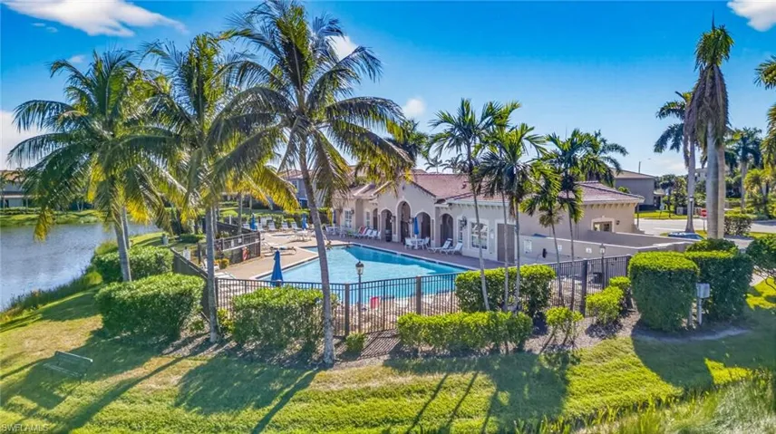 Community pool with a patio and a water view