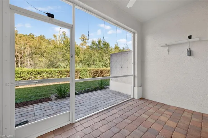 Unfurnished sunroom featuring a ceiling fan