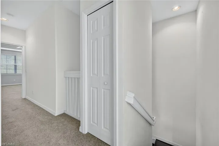 Hall with recessed lighting and carpet