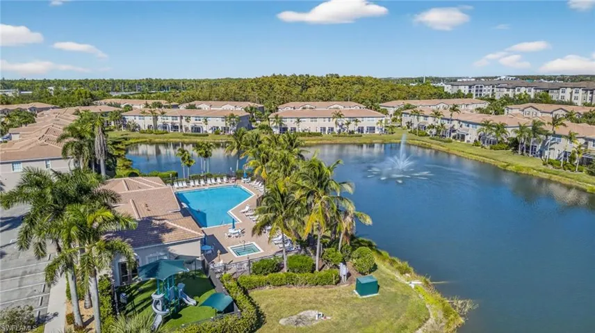 Drone / aerial view of a nearby body of water and a pool