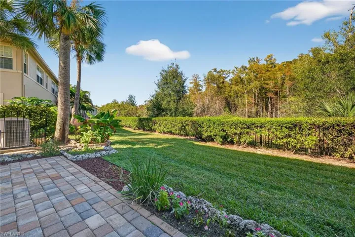 View of green lawn featuring a patio
