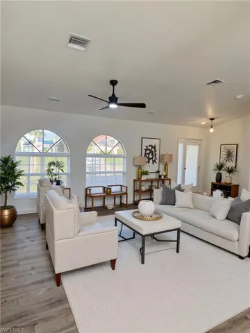 Living area featuring light wood-style floors and ceiling fan