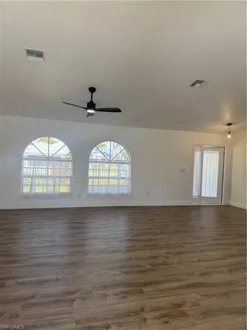 Empty room with wood finished floors and plenty of natural light