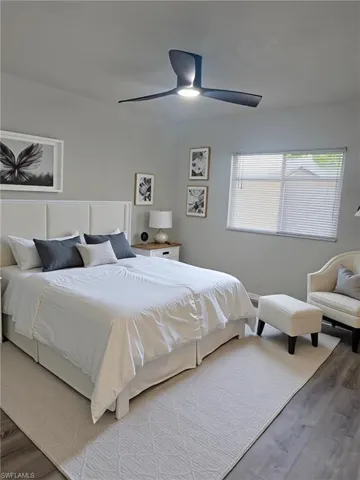 Bedroom with wood finished floors and ceiling fan