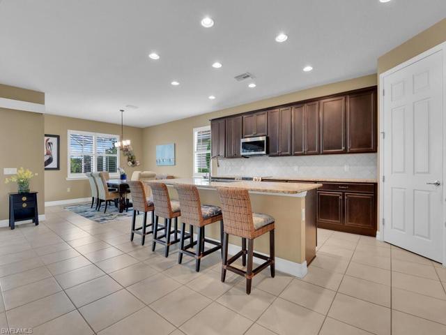 Rich wood cabinetry, stainles appliances, granite countertops and walk-in pantry