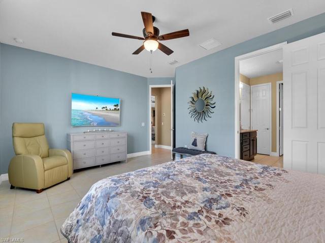 Primary Bedroom with ceramic tile floors and wide blade wood plantation shutters
