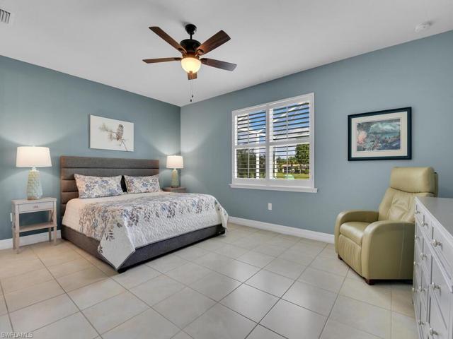 Primary Bedroom with ceramic tile floors and wide blade wood plantation shutters.