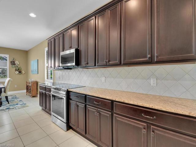 Rich wood cabinetry, stainles appliances, granite countertops and walk-in pantry
