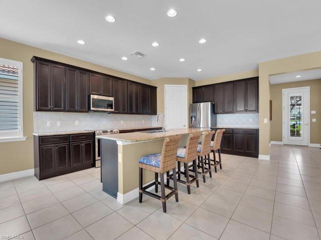 Rich wood cabinetry, stainles appliances, granite countertops and walk-in pantry