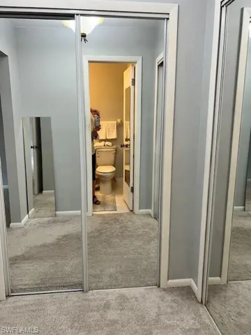 Bathroom featuring light carpet and toilet
