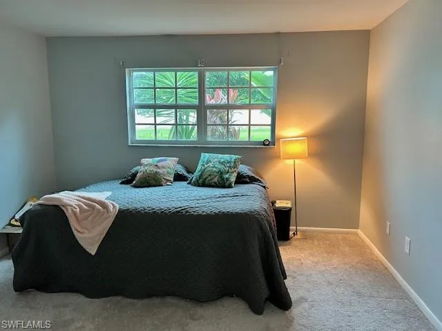 Carpeted bedroom with baseboards