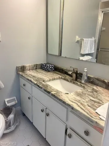 Bathroom featuring light tile patterned floors and vanity