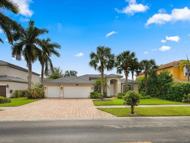 View of front of property featuring a front yard and a garage