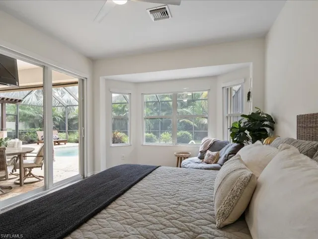 Bedroom featuring multiple windows, access to exterior, and ceiling fan