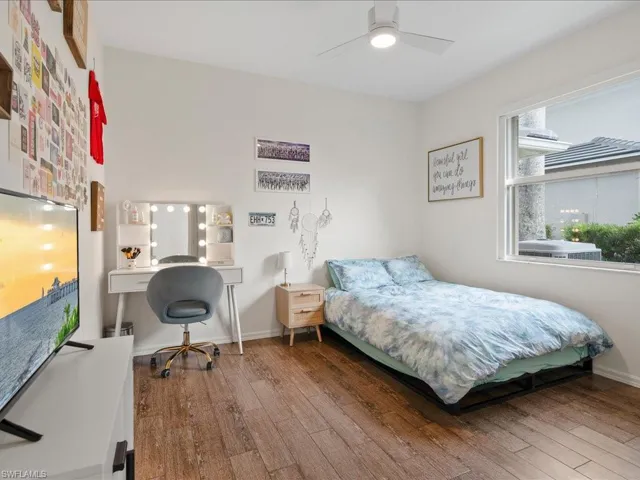 Bedroom featuring ceiling fan and wood-type flooring