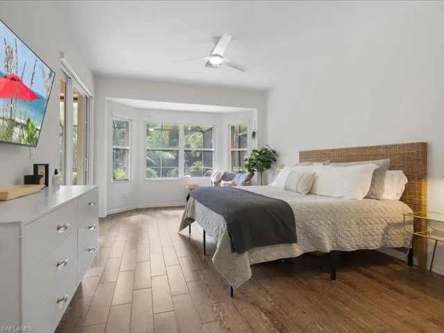 Bedroom featuring ceiling fan and dark hardwood / wood-style floors