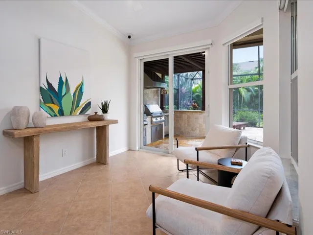 Sitting room featuring crown molding and light tile patterned floors