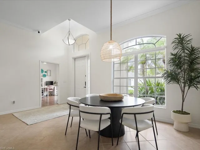 Tiled dining room featuring ornamental molding