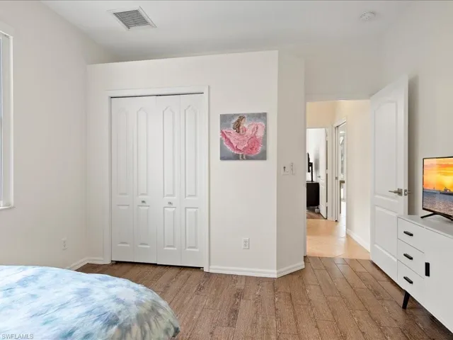 Bedroom featuring light hardwood / wood-style floors and a closet