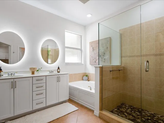 Bathroom with vanity, shower with separate bathtub, and tile patterned flooring