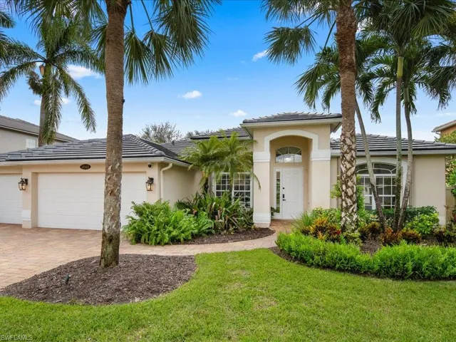View of front facade with a front yard and a garage