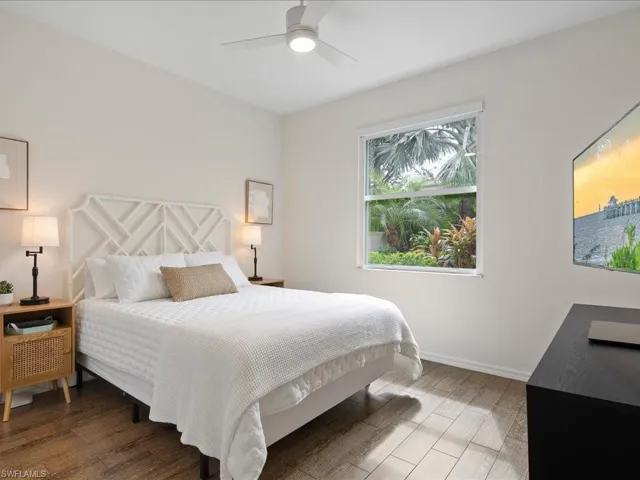 Bedroom featuring ceiling fan and dark hardwood / wood-style floors