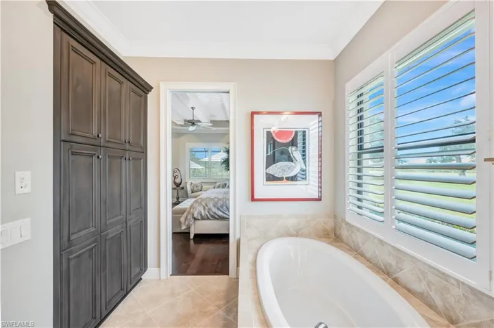 Soaking tub & a wall of additional cabinetry in master