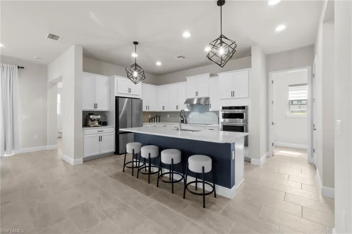 Just off the kitchen is the Full-Size Laundry Room with utility sink and custom built-in cabinets