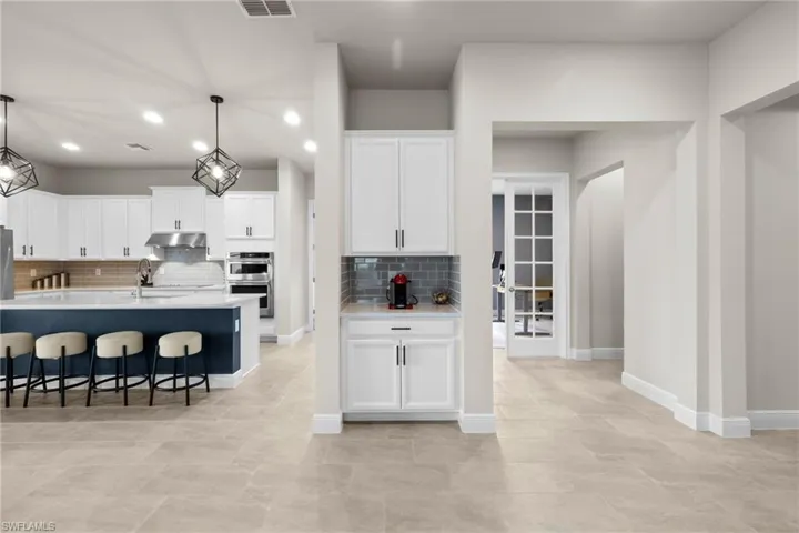 Past the coffee Bar on our way to the dedicated home Office/Den with glass French doors