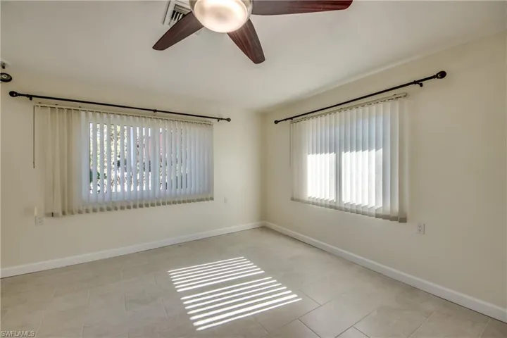 Spare room with ceiling fan and light tile patterned flooring