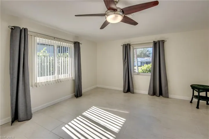 Spare room with ceiling fan and light tile patterned floors