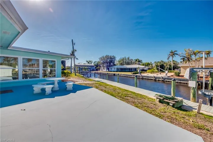 View of swimming pool featuring a water view and a patio area