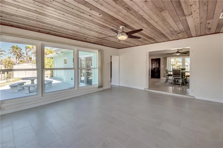 Empty room featuring ceiling fan and wood ceiling