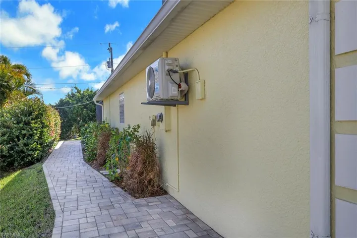 View of property exterior featuring stucco siding and a cooling unit