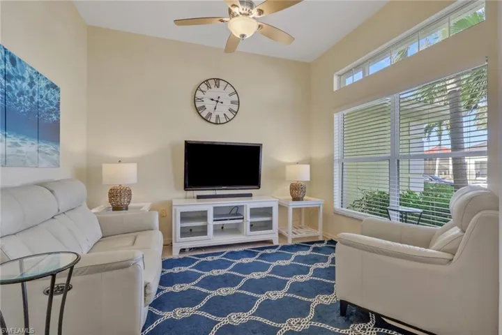 Living area featuring a ceiling fan and baseboards